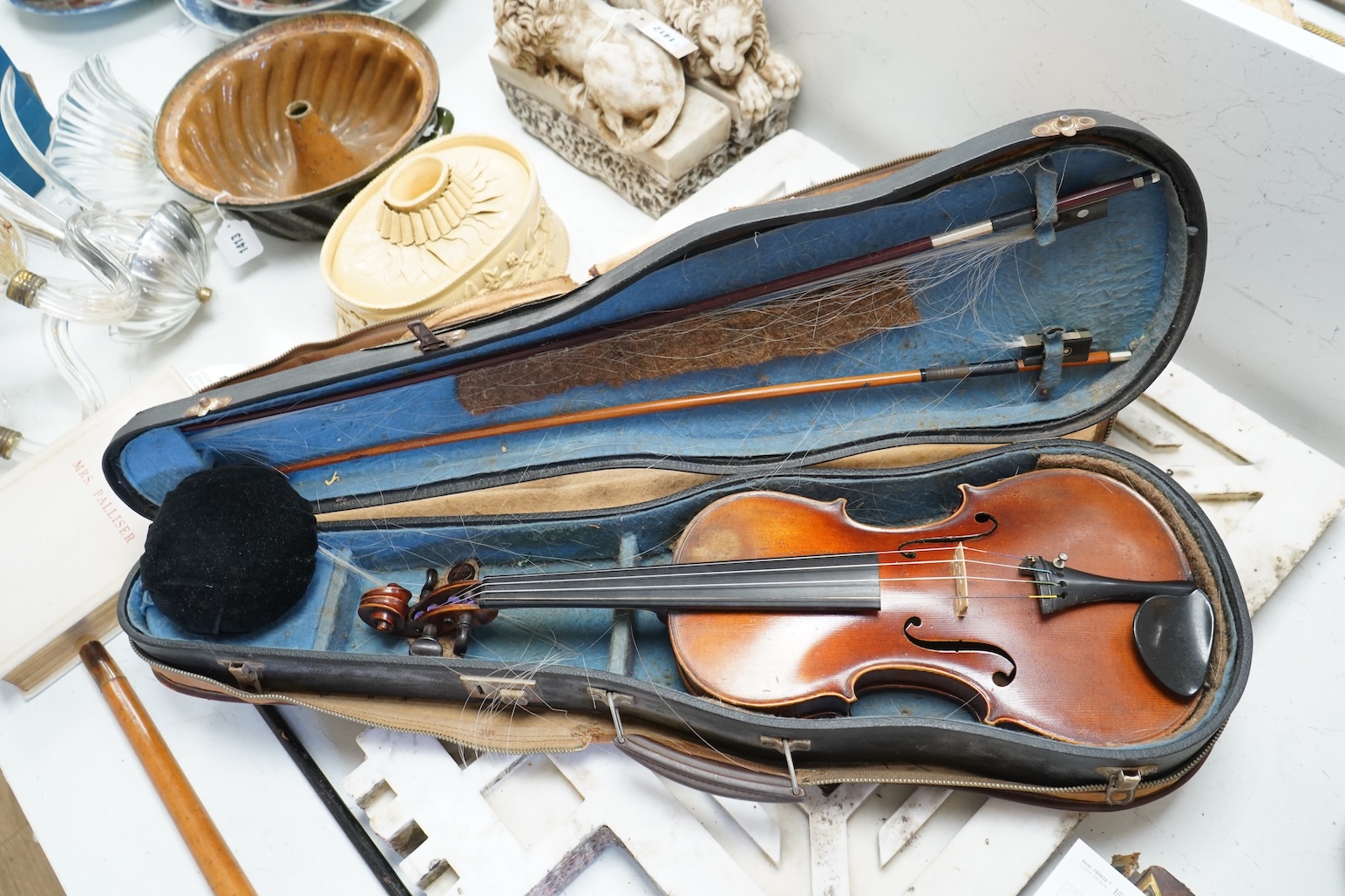 An early 20th century cased violin and cover, 60cm long